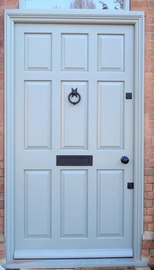 Pale blue painted panelled timber front door