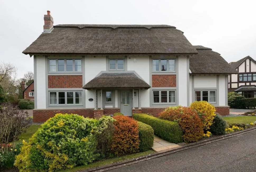 White timber windows on a thatched house