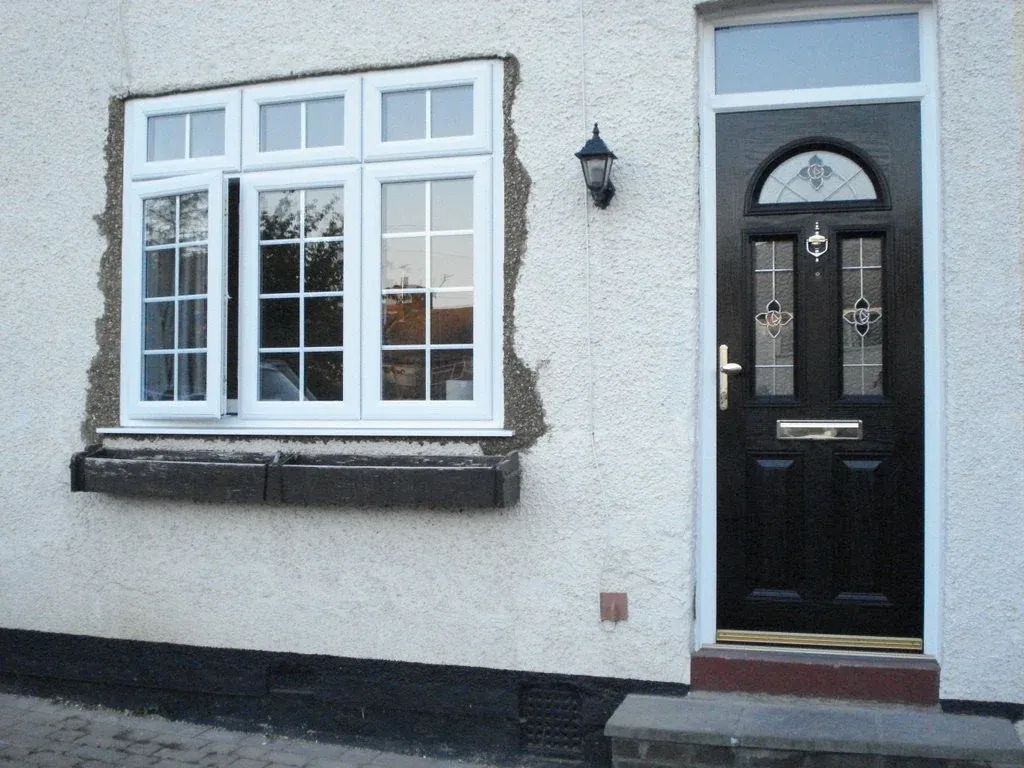 White uPVC windows and black composite front door